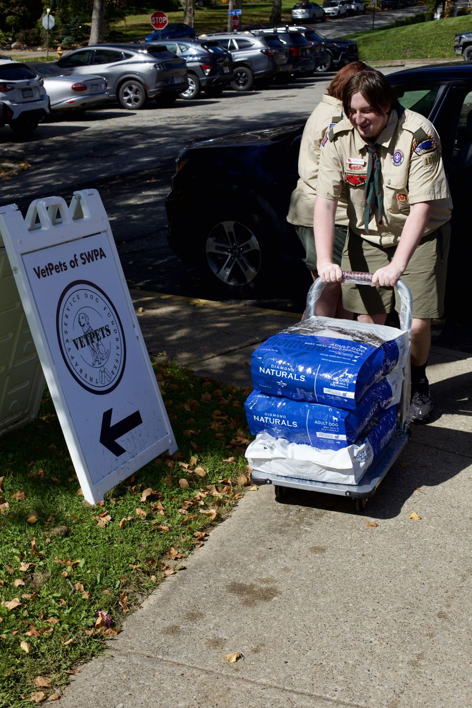 A Scout wheeling a cart of Diamond Naturals dog food past the VetPets of SWPA sign